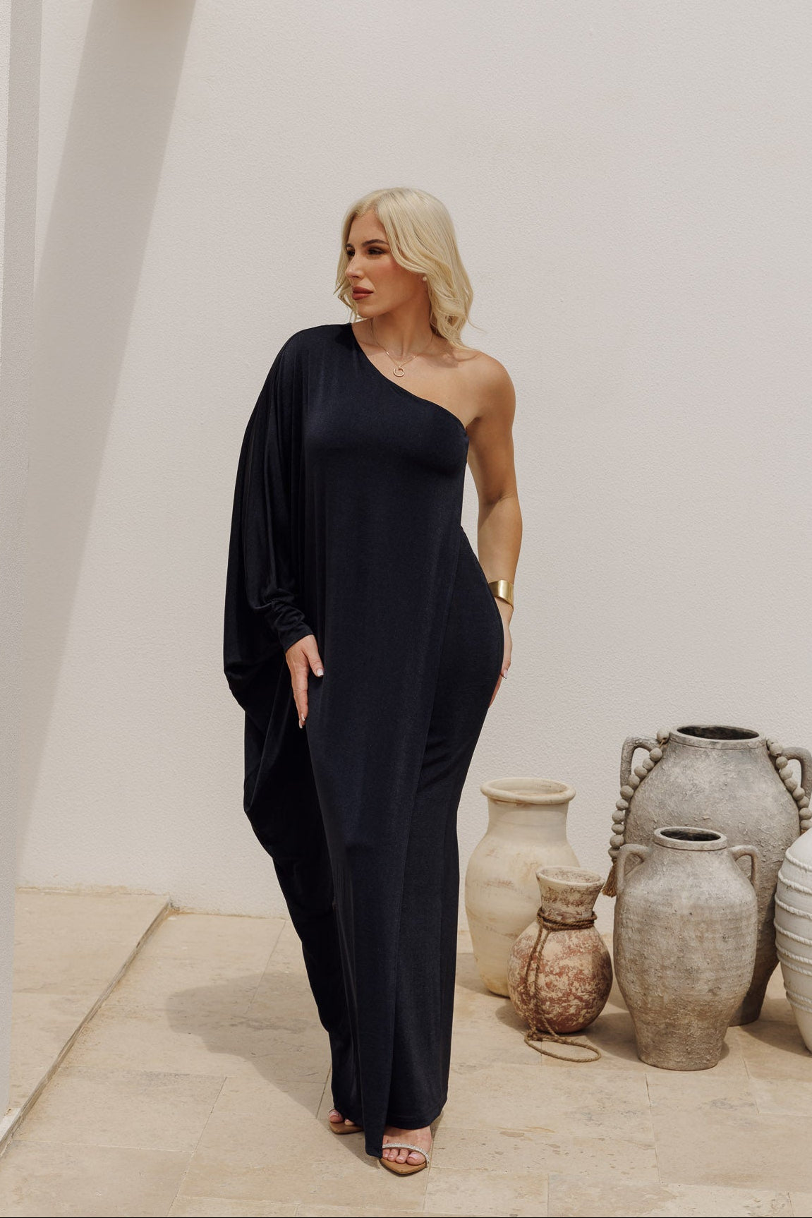 Chic navy one-shoulder dress with flowing drape, perfect for evening and resort wear