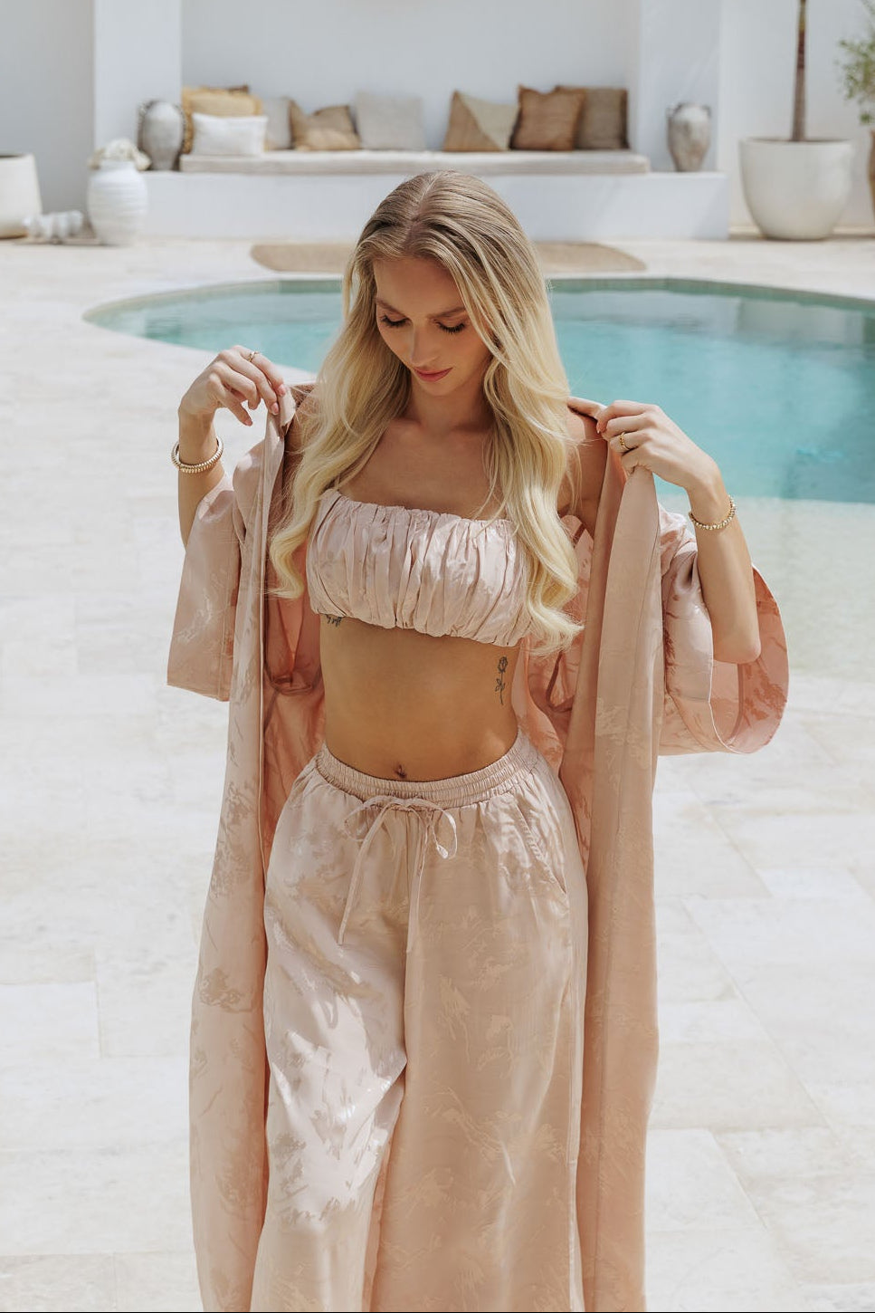 Beige co-ord with bandeau top, wide-leg trousers and flowing kimono, understated elegance in motion