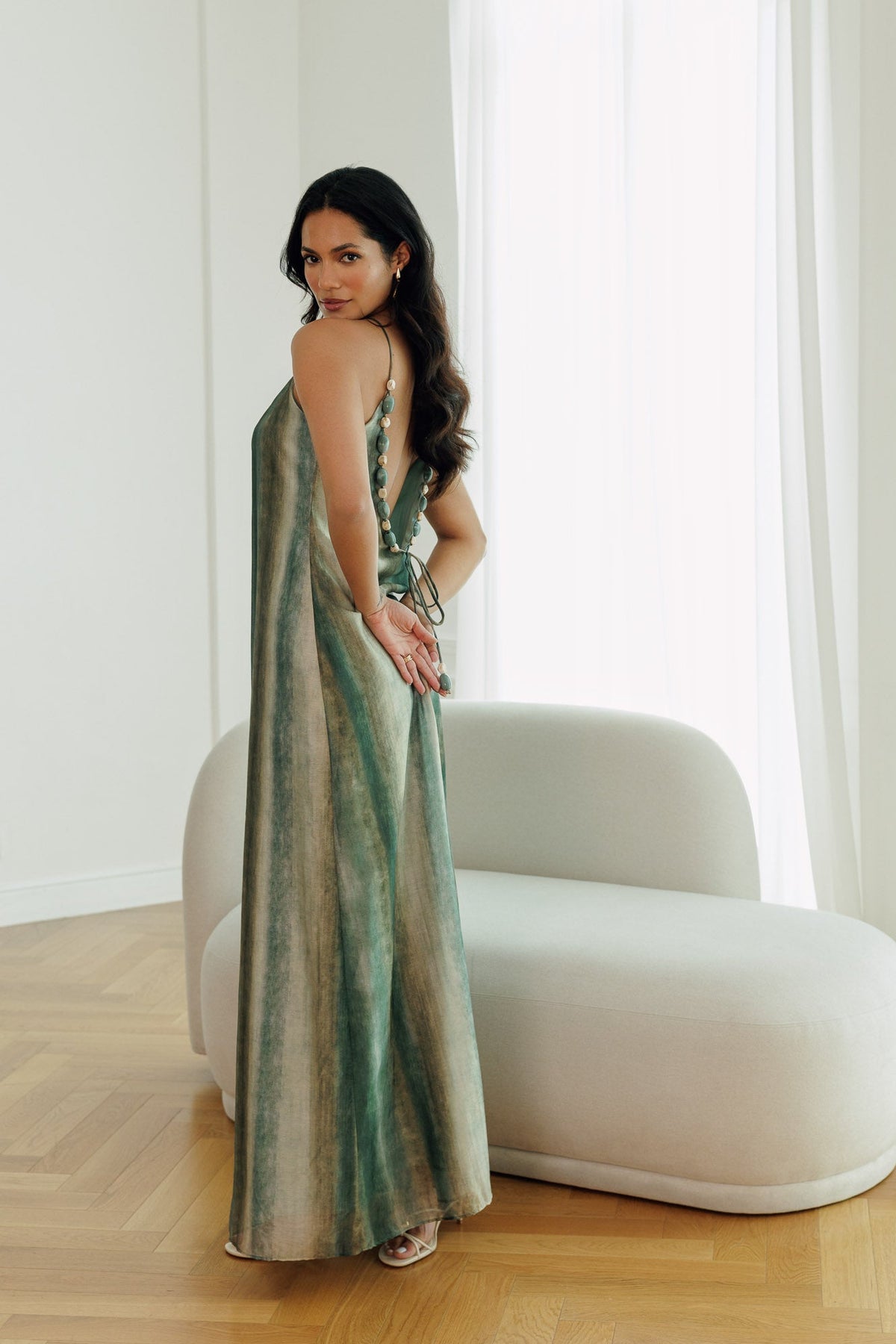 Evi maxi dress featuring an open back with decorative stone and bead detailing.