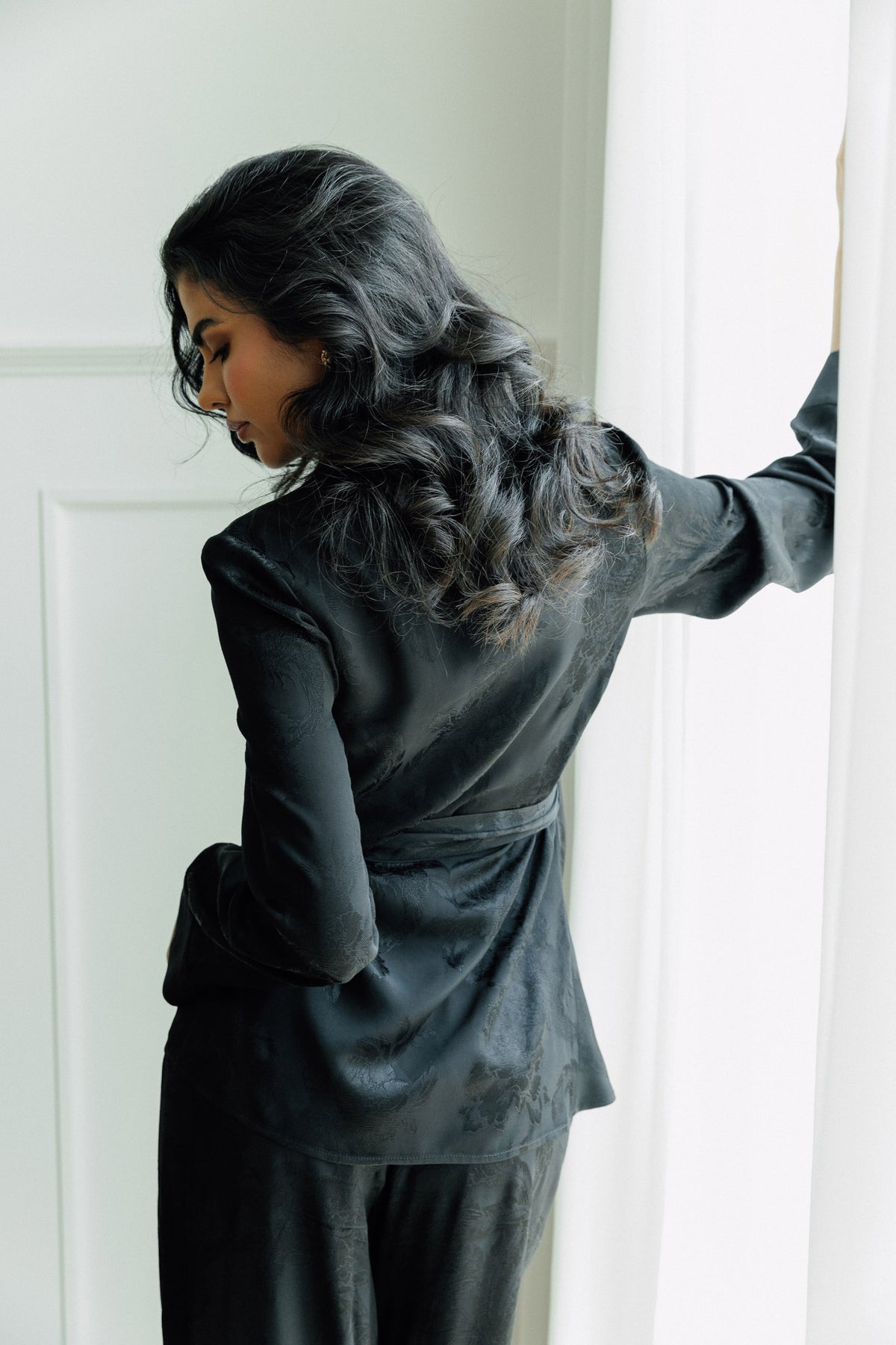 Lilah tailored black two-piece set with fitted blazer and wide-leg trousers.