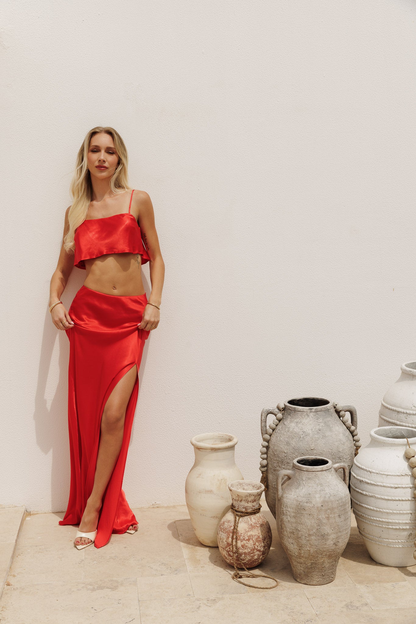 Vibrant red two-piece set featuring a cropped top and high-waisted maxi skirt, bold feminine look