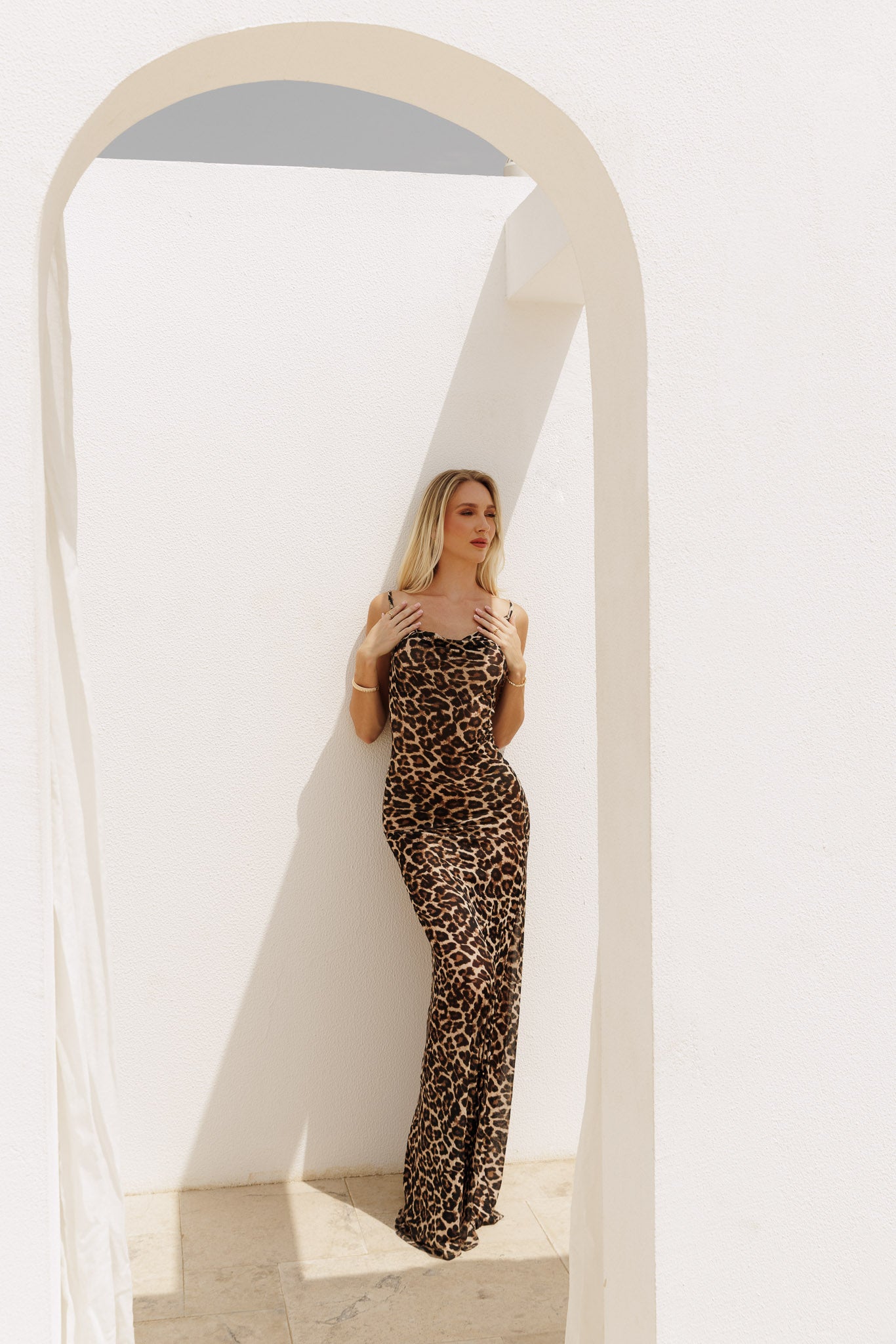 Sleek leopard print evening dress with slim straps and body-contouring silhouette