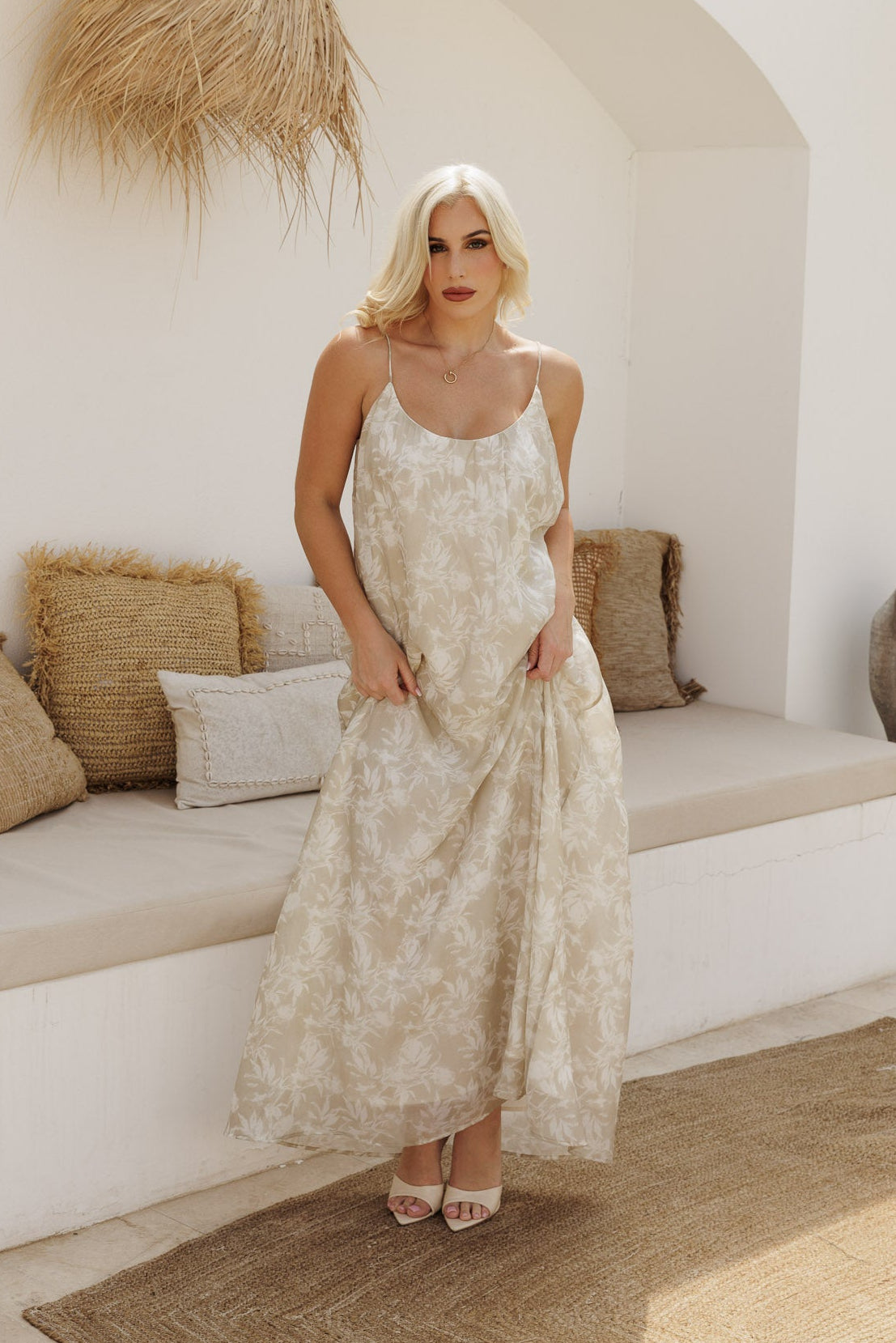 Flowy beige floral maxi dress with spaghetti straps, ideal for beach holidays and warm-weather styling