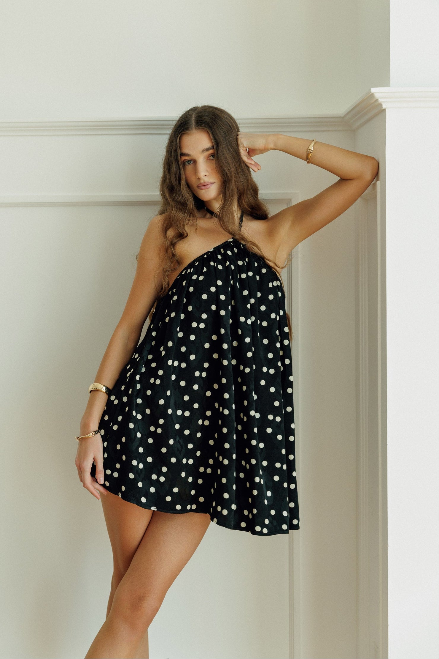 Model wearing the black polka-dot Anaya mini dress