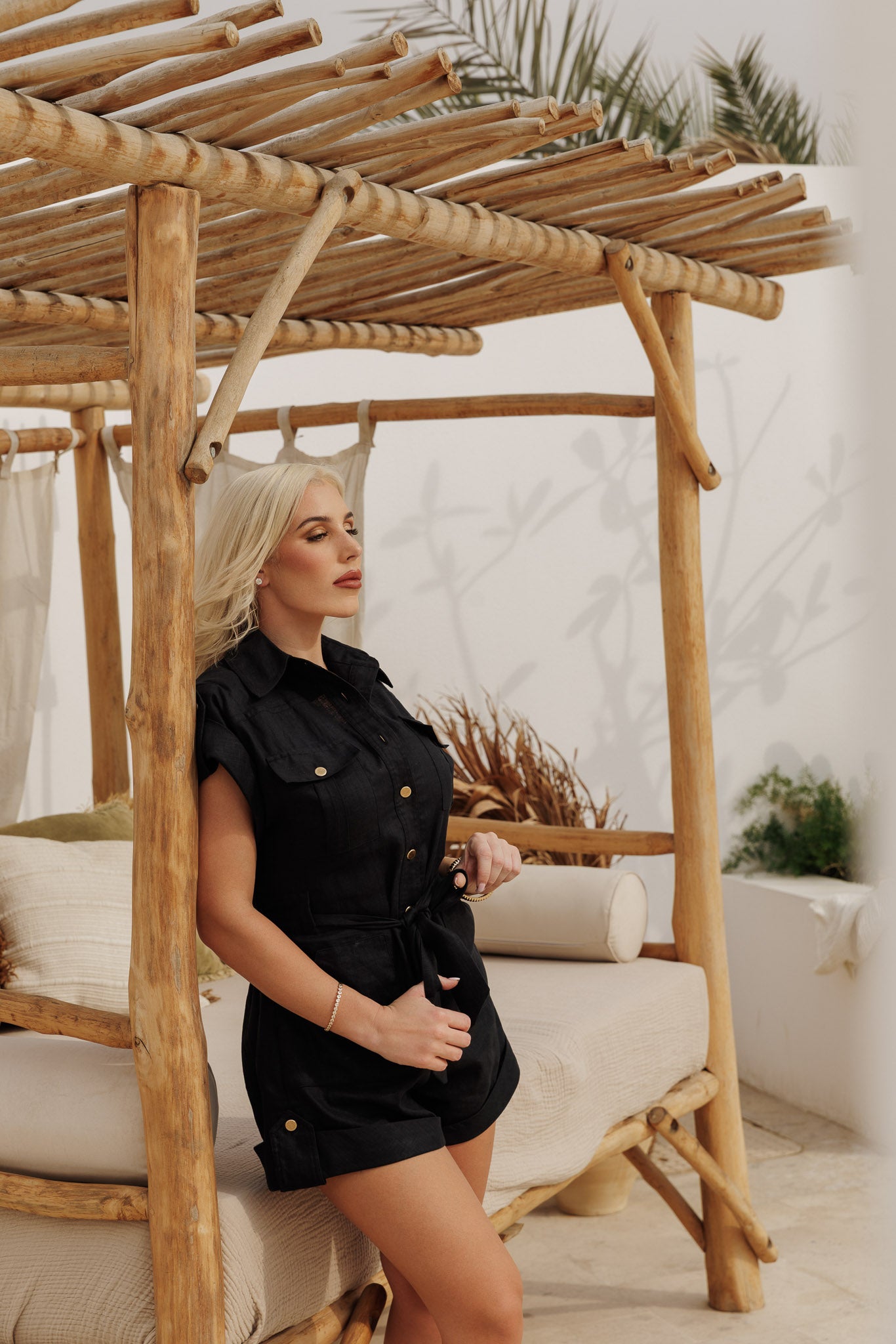 Black linen belted romper with front pockets and tailored fit, modern utility-inspired look