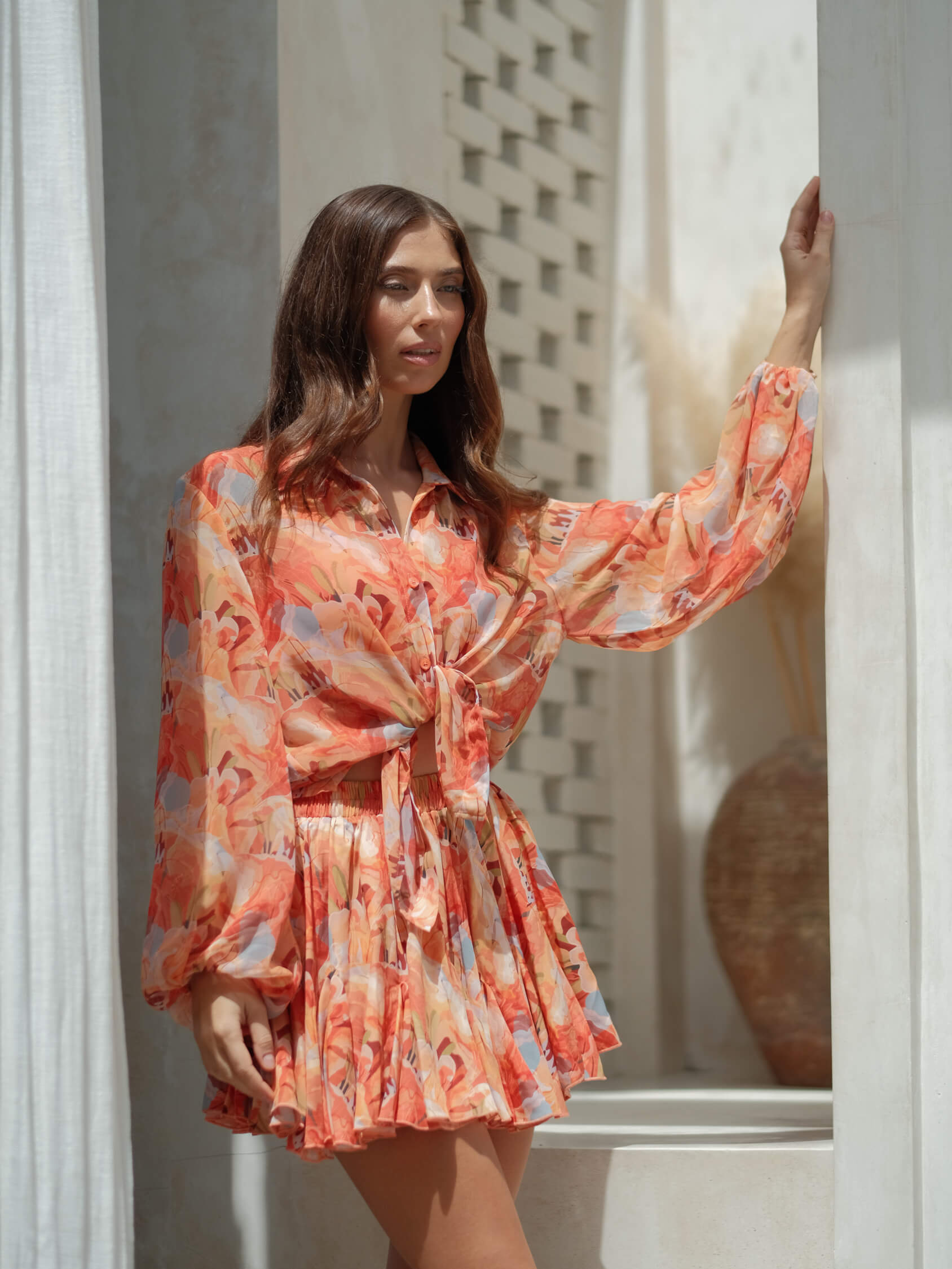 Flowy coral chiffon shirt paired with matching skirt, relaxed fit resort-ready outfit