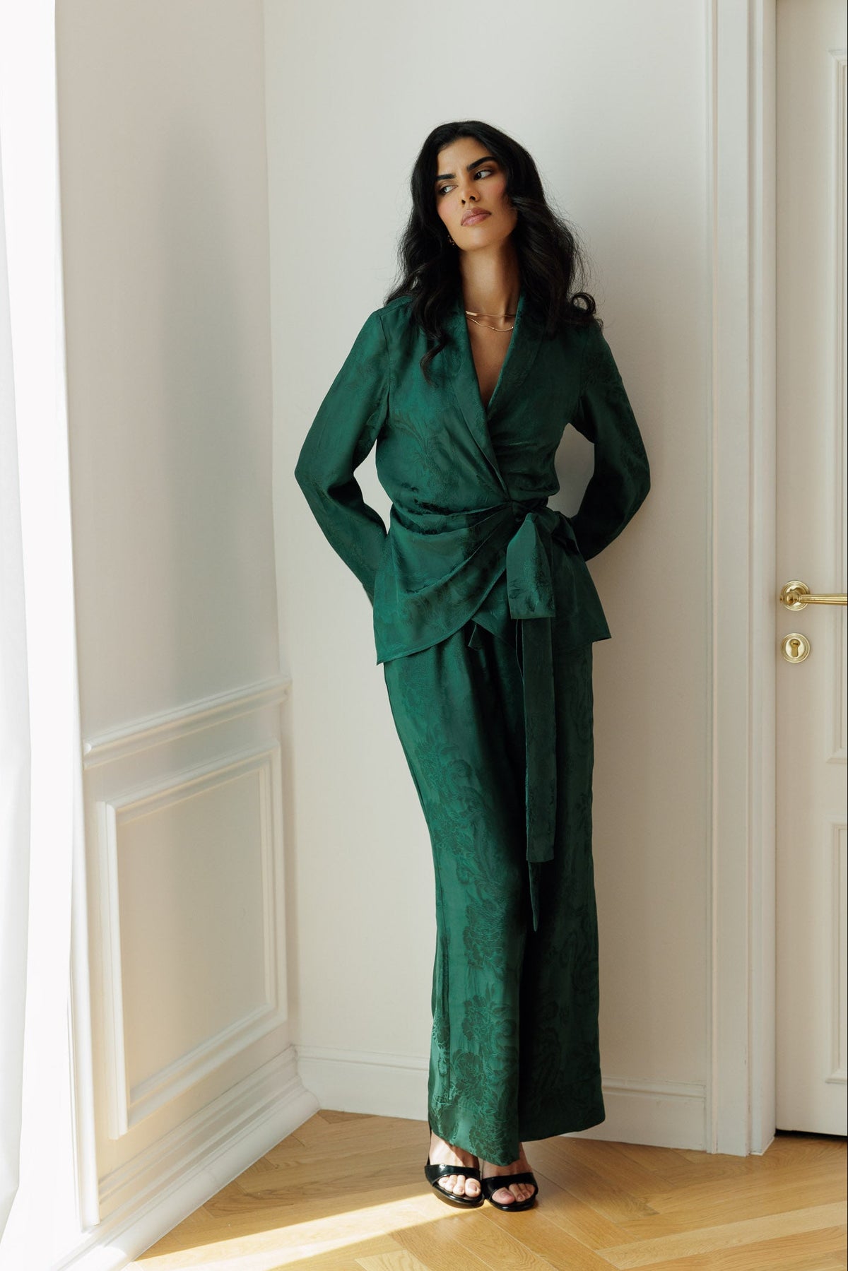 Model wearing the Lilah forest green wrap blazer and matching wide-leg trousers