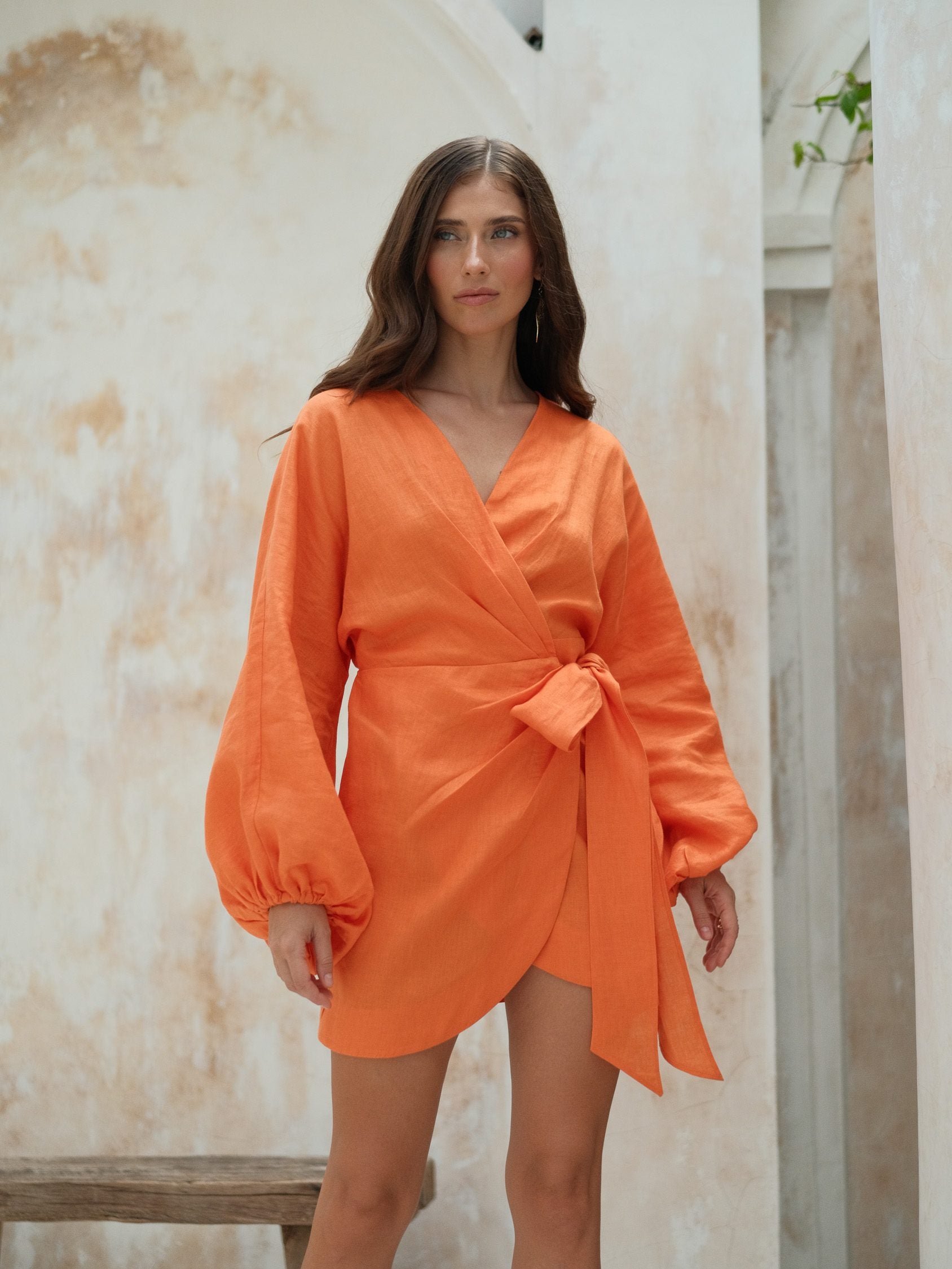 Orange linen dress with voluminous sleeves and wrap detail