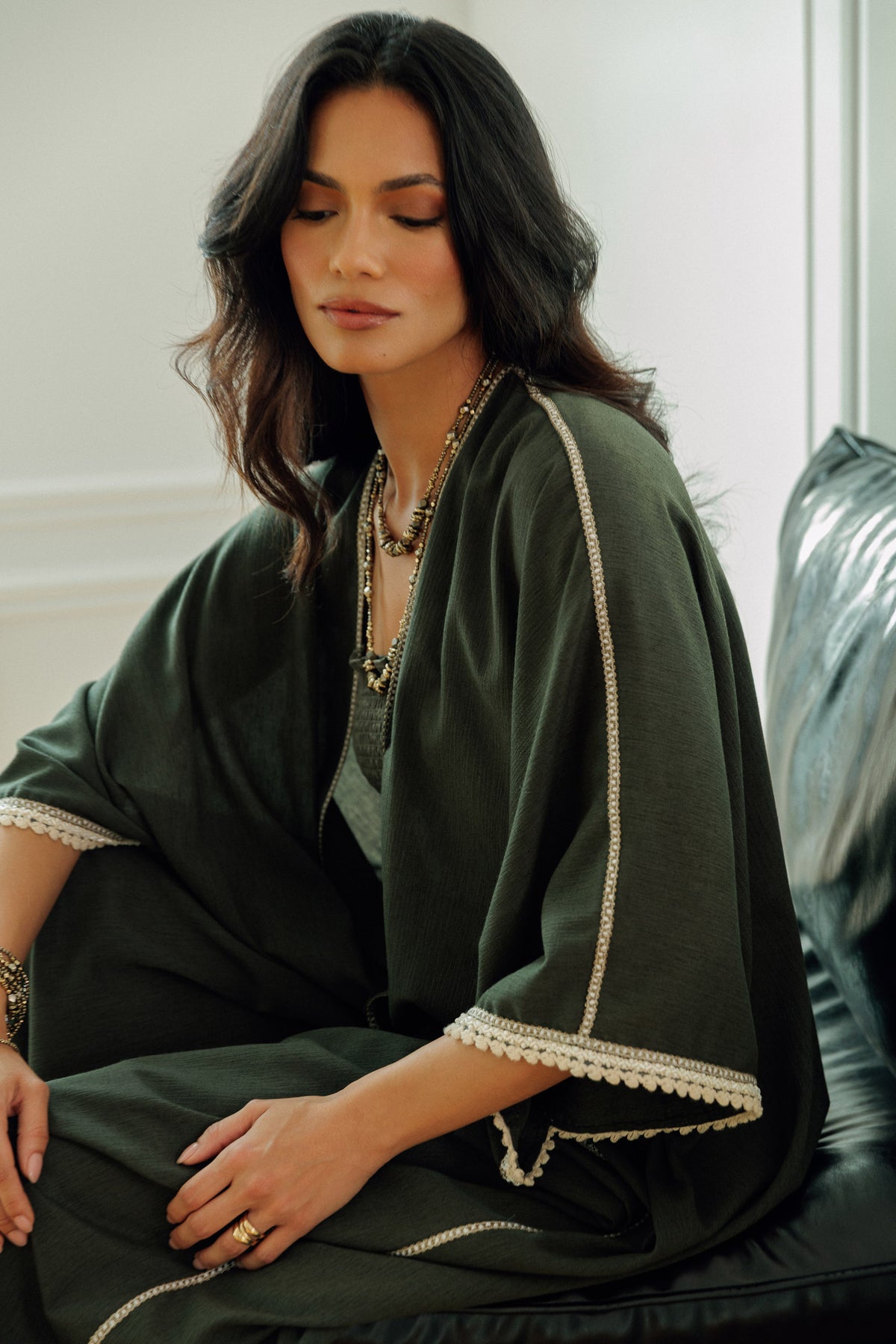 Olive green Nellie kaftan styled over a matching dress