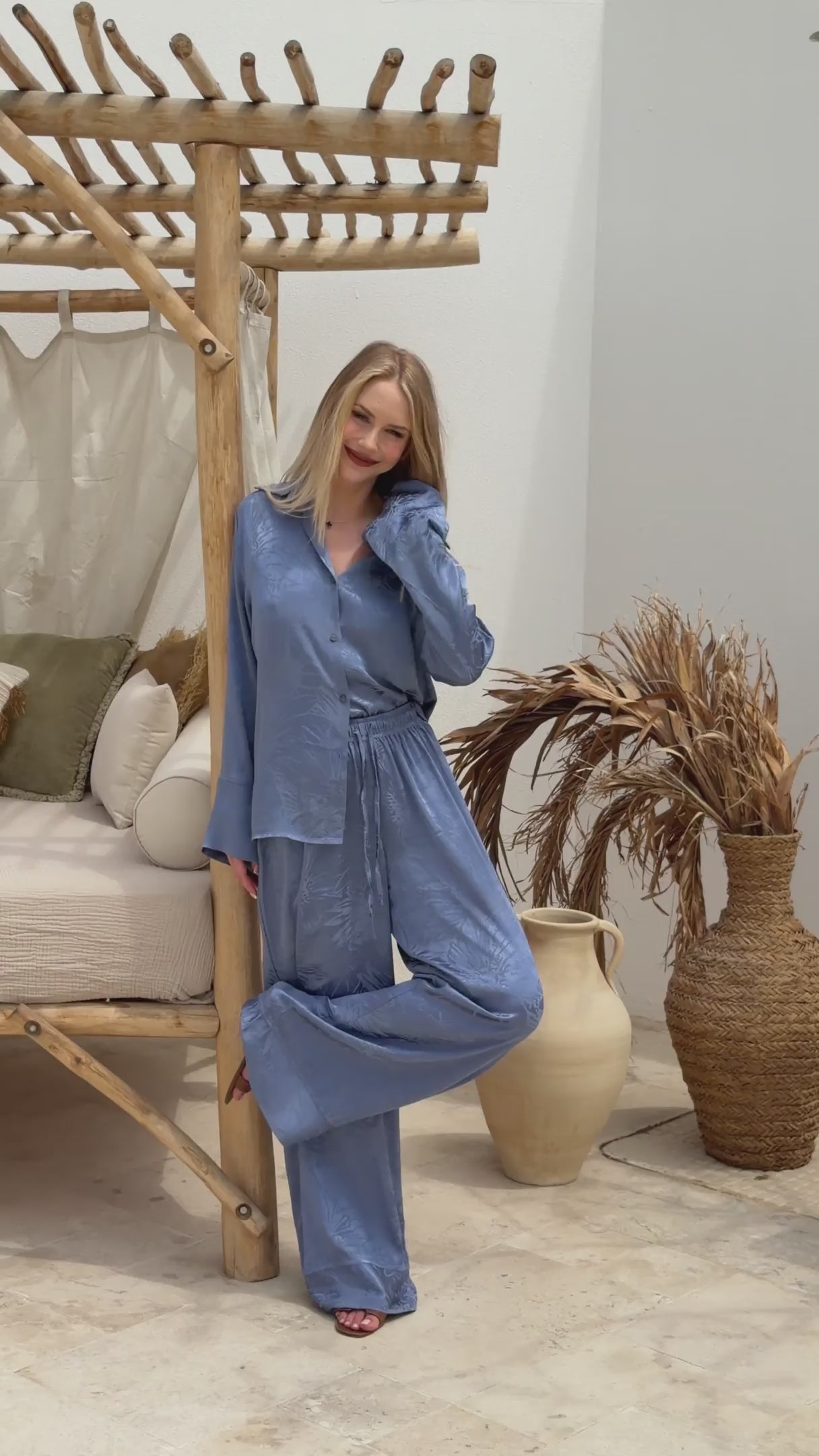Luxury blue satin lounge set with relaxed tailoring and soft sheen, ideal for warm-weather escapes and stylish resort dressing.
